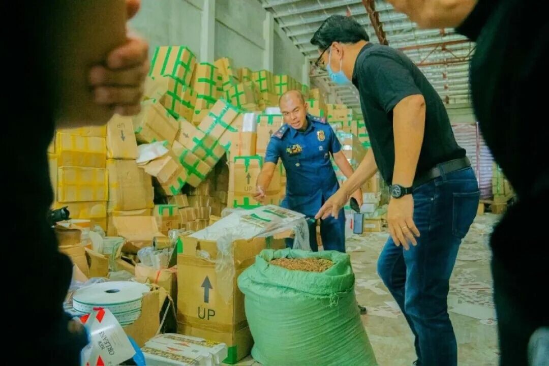 MAYOR  Greg Gasataya and police inspect packaging supplies and raw materials for cigarette manufacturing in a warehouse at the boundaries of Barangay Alijis and Singcang-Airport, Bacolod City on April 22. (Bacolod City Communications Office)