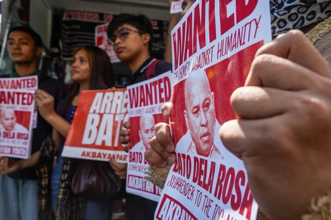 Members of Akbayan Youth stage a poster-pasting action at Kalayaan Avenue Quezon City on Monday, May 18, 2026, putting up “Wanted: Bato” materials against Senator Ronald “Bato” dela Rosa amid calls for accountability following developments involving the International Criminal Court. (John Louie Abrina)