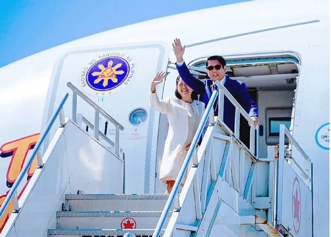 FLYING HOME President Marcos and first lady Liza Araneta-Marcos wave goodbye on board the chartered plane that brought them back to Manila in photo posted by the first lady on Facebook.